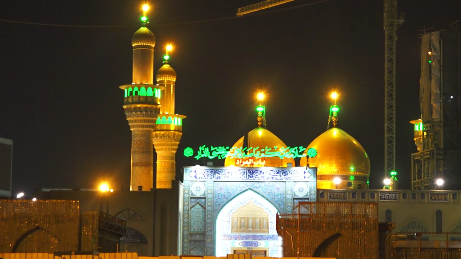 The twin gold domes of the Kadhimiya shrine at night